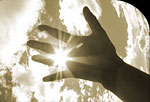 Image of sun through fingers